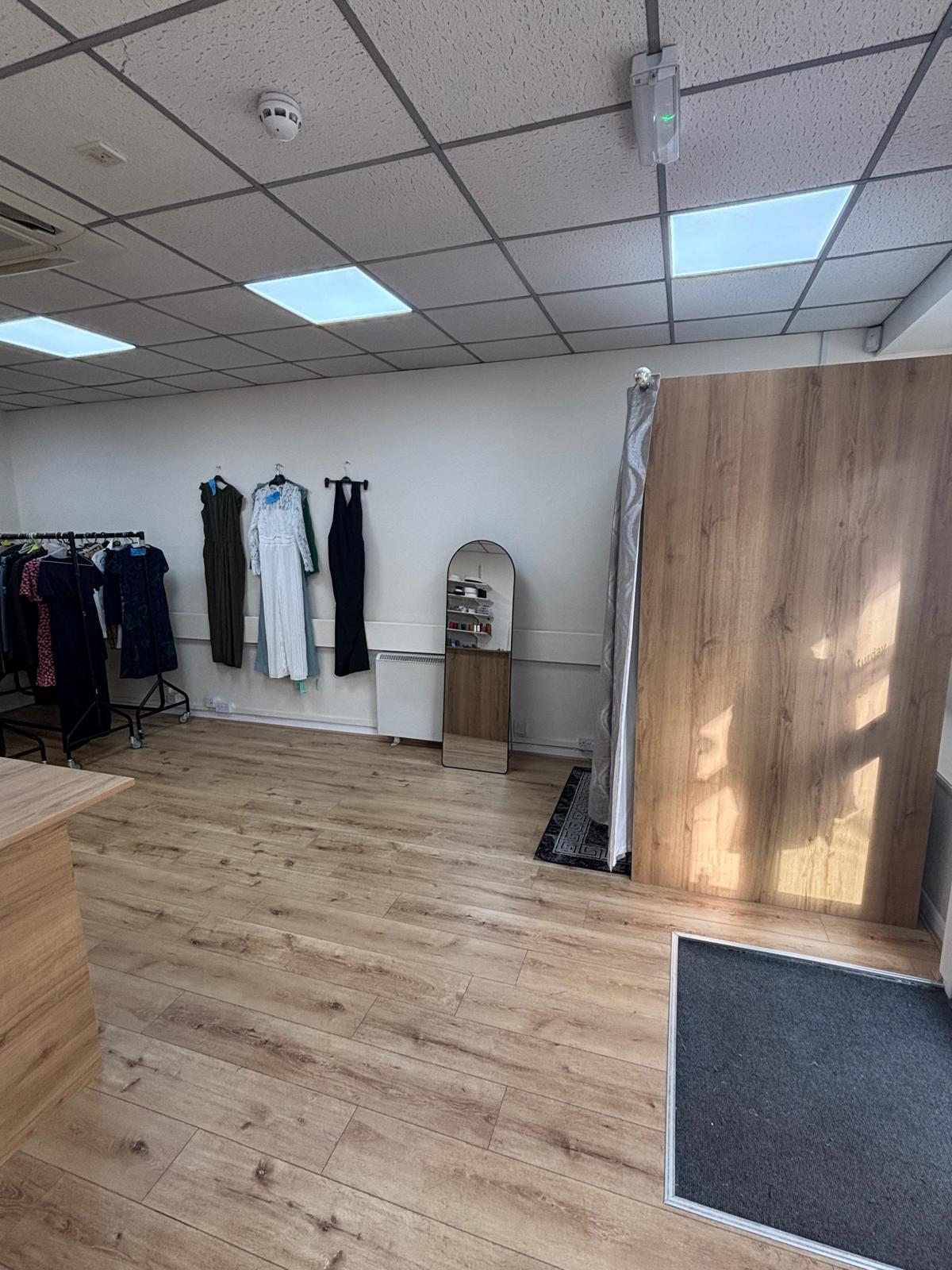 Full-length mirror, fitting curtain and garments in the Stitch & Sew fitting area